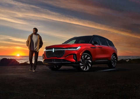 A person is shown next to a 2024 Lincoln Nautilus® SUV as the Lincoln Embrace sequence takes place. | Bluebonnet Motors Lincoln in New Braunfels TX