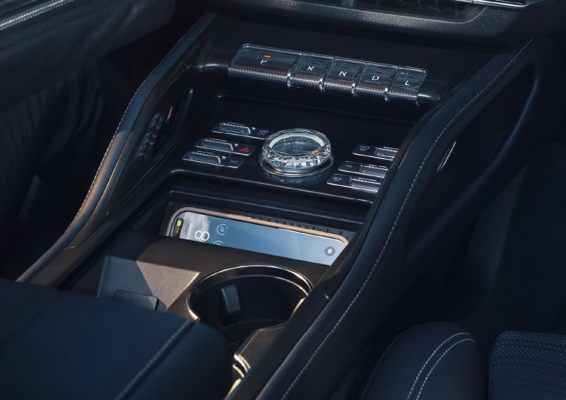 A smartphone is shown charging in the wireless charging pad. | Bluebonnet Motors Lincoln in New Braunfels TX