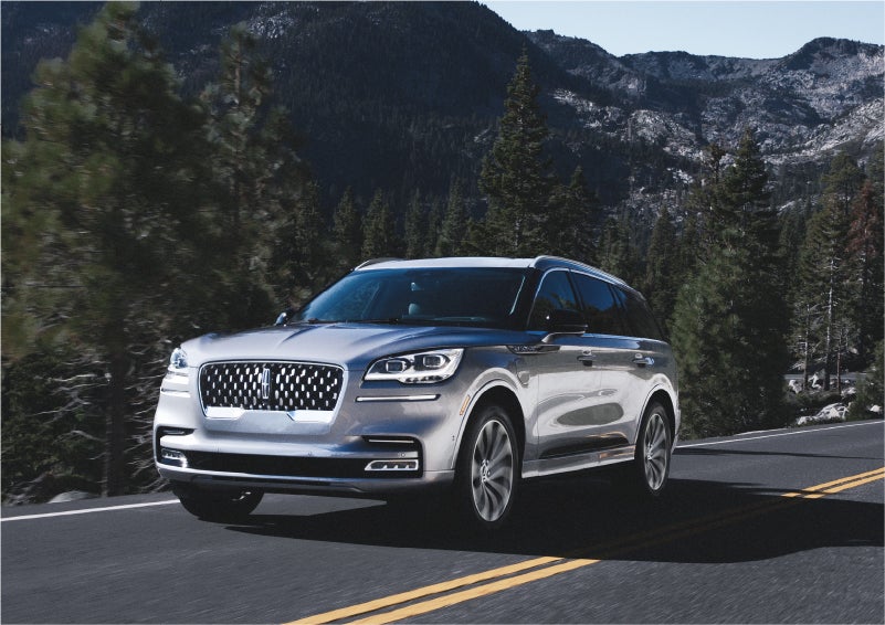 A 2023 Lincoln Aviator® Grand Touring SUV being driven on a winding road to demonstrate the capabilities of all-wheel drive | Bluebonnet Motors Lincoln in New Braunfels TX