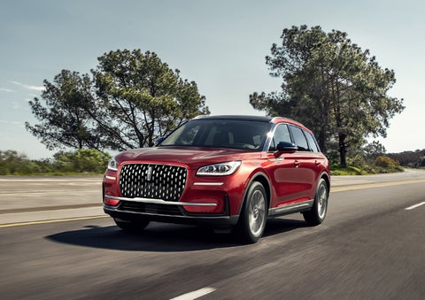 A 2024 Lincoln Corsair® SUV is shown being driven on a country road. | Bluebonnet Motors Lincoln in New Braunfels TX