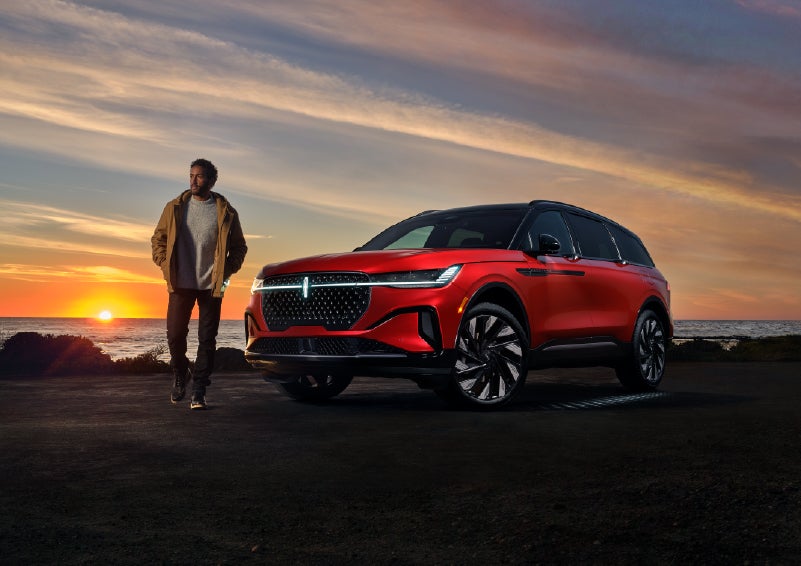 A person is shown next to a 2025 Lincoln Nautilus® SUV as the Lincoln Embrace sequence takes place. | Bluebonnet Motors Lincoln in New Braunfels TX