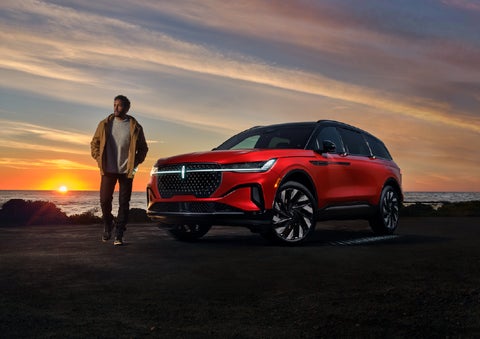 A person is shown next to a 2025 Lincoln Nautilus® SUV as the Lincoln Embrace sequence takes place. | Bluebonnet Motors Lincoln in New Braunfels TX