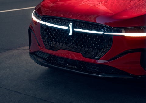 The available front LED light bar and center Lincoln Star logo glow at dusk. | Bluebonnet Motors Lincoln in New Braunfels TX