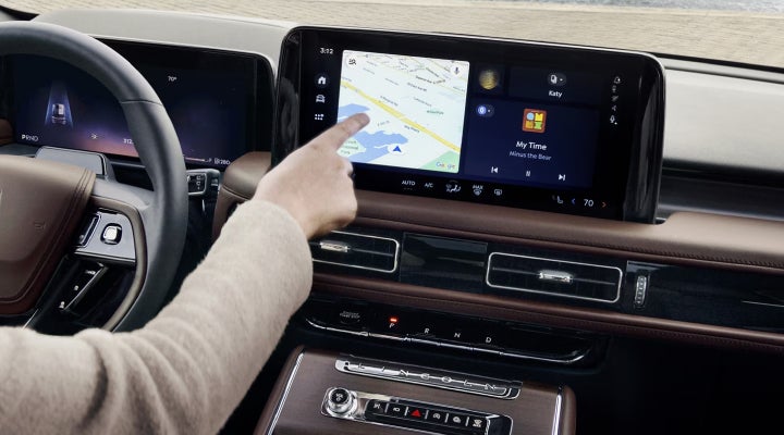 A person is tapping the center display touchscreen of a 2026 Lincoln Aviator® SUV. | Bluebonnet Motors Lincoln in New Braunfels TX