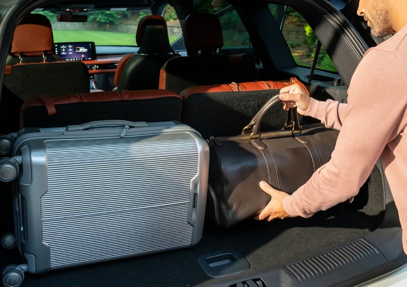 A man loads luggage into the rear of a 2026 Lincoln Aviator® SUV through the opened rear liftgate. | Bluebonnet Motors Lincoln in New Braunfels TX
