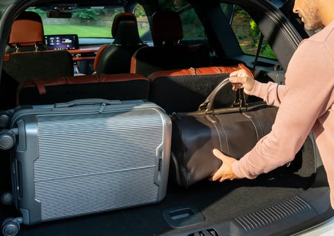 A man loads luggage into the rear of a 2026 Lincoln Aviator® SUV through the opened rear liftgate. | Bluebonnet Motors Lincoln in New Braunfels TX