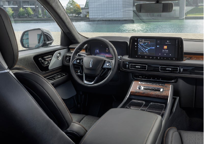 The interior of the 2026 Lincoln Aviator® SUV is shown parked with a view of a harbor through the windshield. | Bluebonnet Motors Lincoln in New Braunfels TX