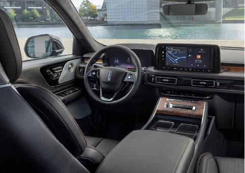 The interior of the 2026 Lincoln Aviator® SUV is shown parked with a view of a harbor through the windshield. | Bluebonnet Motors Lincoln in New Braunfels TX
