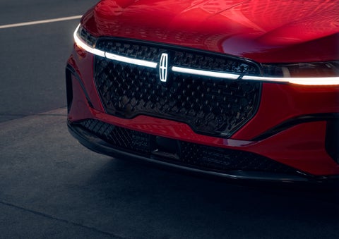 The available front LED light bar and center Lincoln Star logo glow at dusk. | Bluebonnet Motors Lincoln in New Braunfels TX