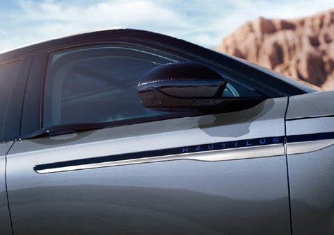 Blue lettering on the side of the vehicle that reads Nautilus indicates the available Hybrid Powertrain. | Bluebonnet Motors Lincoln in New Braunfels TX