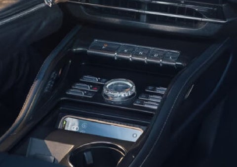 A smartphone is shown charging in the wireless charging pad. | Bluebonnet Motors Lincoln in New Braunfels TX