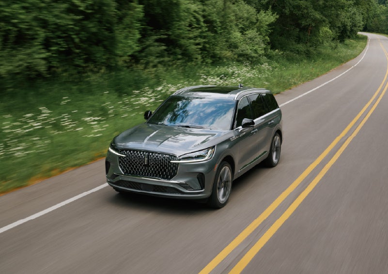 A 2027 Lincoln Aviator® SUV is being driven down a road. | Bluebonnet Motors Lincoln in New Braunfels TX