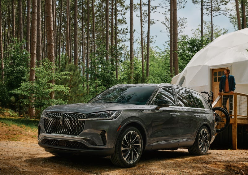 A 2027 Lincoln Aviator® is parked next to a high end glamping site. | Bluebonnet Motors Lincoln in New Braunfels TX