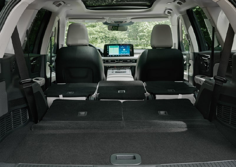 A rear to front view of the interior of a 2027 Lincoln Aviator® Black Label™ SUV shows the third and second rows folded flat | Bluebonnet Motors Lincoln in New Braunfels TX