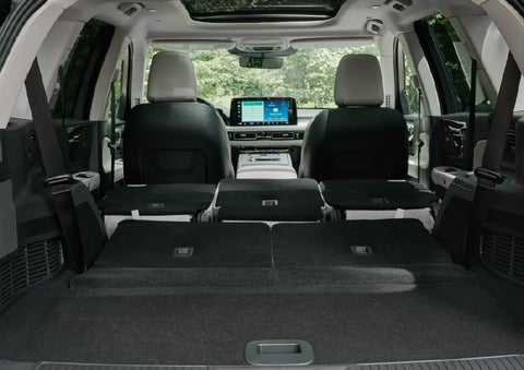 A rear to front view of the interior of a 2027 Lincoln Aviator® Black Label™ SUV shows the third and second rows folded flat | Bluebonnet Motors Lincoln in New Braunfels TX