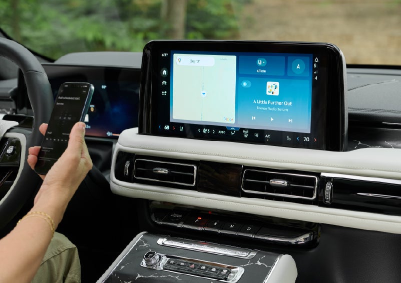 A person pairs thier phone with the center touchscreen of a 2027 Lincoln Aviator® Black Label™ SUV | Bluebonnet Motors Lincoln in New Braunfels TX